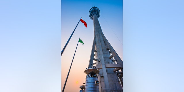 MACAU, CHINA - OCTOBER 12, 2012: Macau Tower exterior at dusk. At 233 meters, the tower offers the second highest commercial bungee jump in the world.