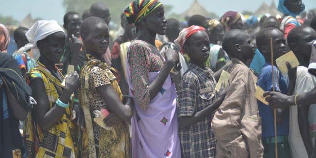 July 25: People waiting for food distribution in Dablual. Soldiers believed to be South Sudanese government troops and allied militia stole relief food and killed seven people in an attack in a rebel-held part of Unity state, a local official said.