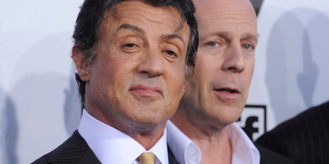 Cast members Sylvester Stallone (L) and Bruce Willis attend the premiere of the film "The Expendables" in Los Angeles August 3, 2010.