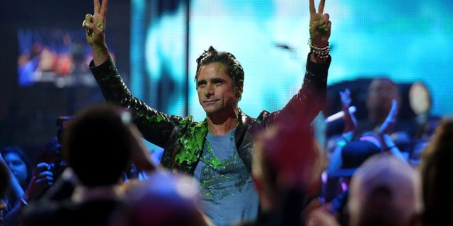 March 12, 2016. John Stamos gets slimed at the Kids' Choice Awards at The Forum on Saturday, March 12, 2016, in Inglewood, Calif.