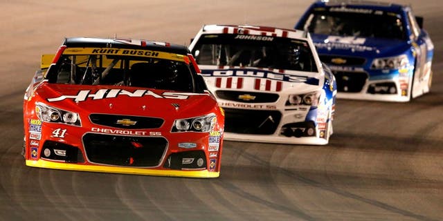 AVONDALE, AZ - NOVEMBER 15: Kurt Busch, driver of the #41 Haas Automation Chevrolet, races Jimmie Johnson, driver of the #48 Lowe's Patriotic Chevrolet, and Dale Earnhardt Jr., driver of the #88 Nationwide Chevrolet, during the NASCAR Sprint Cup Series Quicken Loans Race for Heroes 500 at Phoenix International Raceway on November 15, 2015 in Avondale, Arizona. (Photo by Christian Petersen/Getty Images)