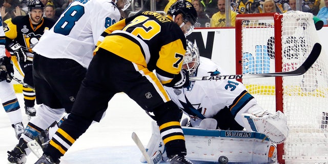 June 9, 2016: San Jose Sharks goalie Martin Jones (31) turns a shot away as Pittsburgh Penguins' Patric Hornqvist (72) and Sharks' Brent Burns (88) scramble in front of the net during the third period in Game 5 of the NHL Stanley Cup Final