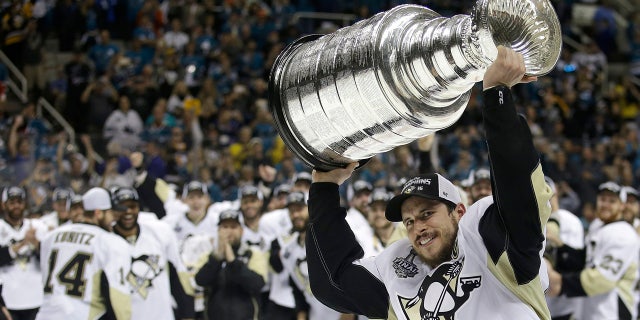 June 12, 2016: Pittsburgh Penguins center Sidney Crosby raises the Stanley Cup after Game 6 of the Stanley Cup Final against the San Jose Sharks.