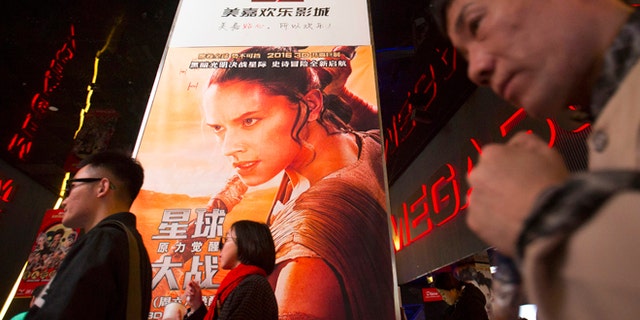 Jan 9, 2016. People walk past a poster for the new "Star Wars" movie at a movie theater in Beijing, China.