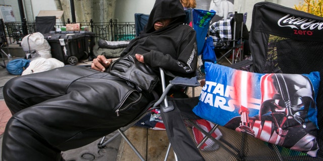 Dec. 9, 2015 . "Star Wars" fan, actor Deuce Wayne, from Virginia, rests outside the TCL Chinese Theater Imax while waiting for the premiere of "Star Wars: The Force Awakens" in Los Angeles.