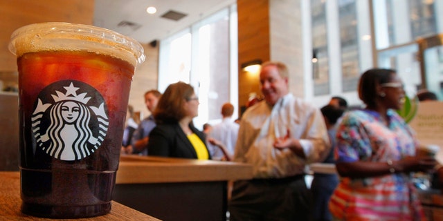 An iced coffee sits on a counter in a Starbucks outlet in New York July 25, 2012. Starbucks Corp. will report earnings on July 26. REUTERS/Brendan McDermid (UNITED STATES - Tags: BUSINESS) - RTR35BIA