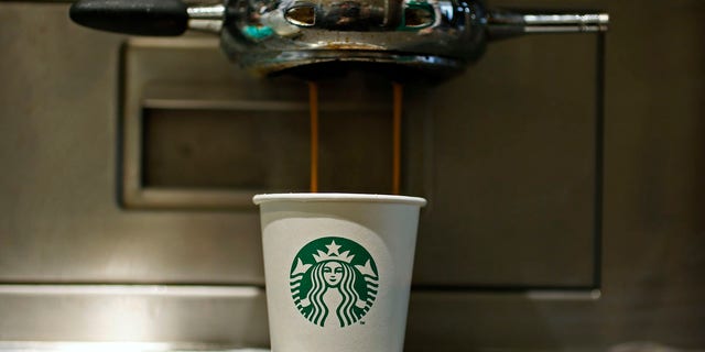 A paper cup is seen in Starbucks' Vigo Street branch in Mayfair, central London January 11, 2013. REUTERS/Stefan Wermuth (BRITAIN - Tags: BUSINESS LOGO FOOD) - LM1E91B1ILX01