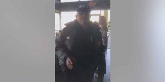 A security guard approaches Ward after the Starbucks employee asks him to leave.