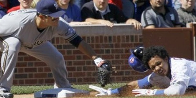 Sept. 21, 2011: Milwaukee Brewers third baseman Jerry Hairston Jr., left, tags Chicago Cubs' Starlin Castro out at third, as Castro tried to stretch his double into a triple during the first inning of a baseball game in Chicago.