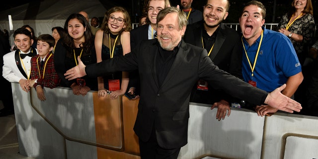 "Star Wars: The Last Jedi" cast member Mark Hamill poses with special guests at the premiere as part of the Make-A-Wish Foundation.