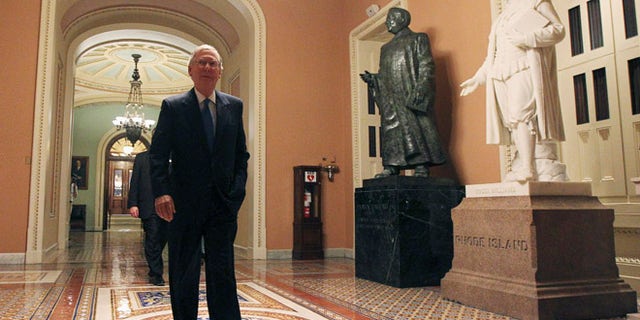 Sept. 30, 2013: U.S. Senate Minority Leader Mitch McConnell (R-KY) walks past statues of former U.S. Senators Patrick Anthony McCarran (2nd R) and Roger Williams (R) as he departs the Senate chamber.