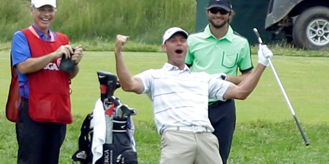 June 16, 2013: Shawn Stefani, center, reacts after hitting a hole in one on the 17th hole during the fourth round of the U.S. Open golf tournament at Merion Golf Club, in Ardmore, Pa.