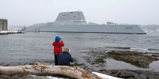 Dave Cleaveland and his son, Cody, photograph the USS Zumwalt.