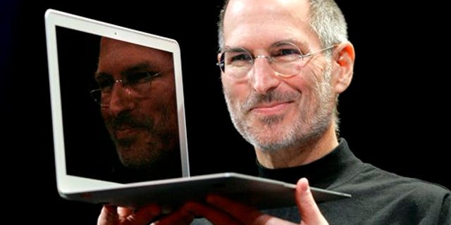 FILE - In this Jan. 15, 2008, file photo, Apple CEO Steve Jobs holds up the new MacBook Air after giving the keynote address at the Apple MacWorld Conference in San Francisco. Apple on Wednesday, Oct. 5, 2011 said Jobs has died. He was 56. (AP Photo/Jeff Chiu, File)