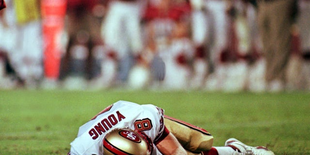 San Francisco 49ers' quarterback Steve Young lays motionless on field after suffering a concussion in the second quarter of the 49ers' game against the Arizona Cardinals Monday Sept. 27, 1999 in Tempe, Arizona.