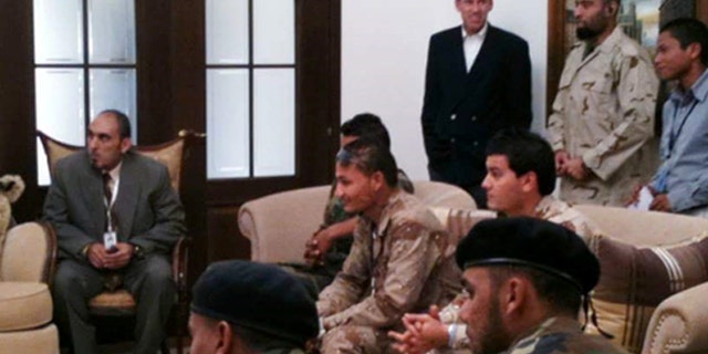 Stevens, shown in rear wearing black, with several of the guards sources say turned on him.
