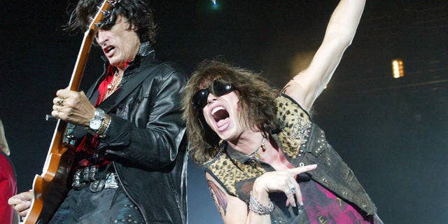 Aerosmith's lead singer Steven Tyler, right, belts out the tune beside guitarist Joe Perry during their Tokyo Dome concert in Tokyo.