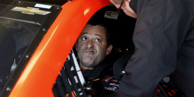 Driver Tony Stewart talks with a crew member as they get ready  to practice for Sunday's NASCAR Sprint Cup series auto race at the Texas Motor Speedway in Fort Worth, Texas, Saturday, Nov. 1, 2014. AP Photo/Jim Cowsert)