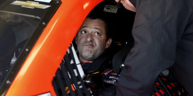 Driver Tony Stewart talks with a crew member as they get ready to practice for Sunday's NASCAR Sprint Cup series auto race at the Texas Motor Speedway in Fort Worth, Texas, Saturday, Nov. 1, 2014. AP Photo/Jim Cowsert)