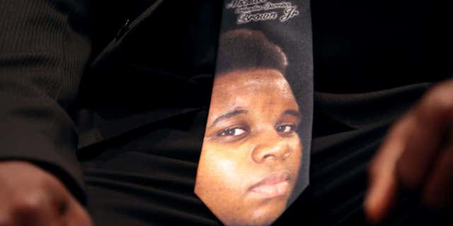 Aug. 25, 2014: A man wears a tie decorated with a picture of Michael Brown during Brown's funeral at Friendly Temple Missionary Baptist Church in St. Louis.