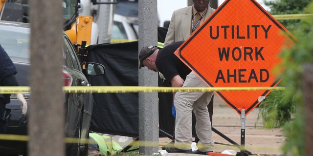 Police investigate a triple shooting in which two Laclede Gas workers were shot and killed in St. Louis on Thursday, April 20, 2017. Police say the shooter also shot and killed himself.
