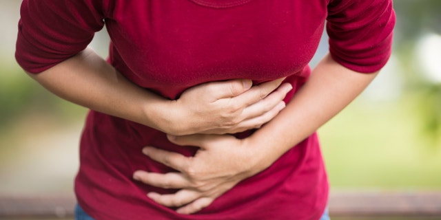 Woman Has Stomach Ache at Park