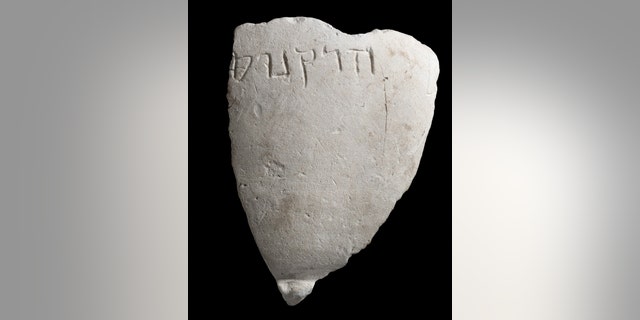 A fragment of the chalk bowl from the Hasmonean period, which is engraved with the name “Hyrcanus”. (Photographic credit: Clara Amit, Israel Antiquities Authority)
