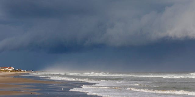A storm front is seen on the beach in North Topsail Beach, N.C., prior to Hurricane Florence moving toward the east coast on Wednesday, Sept. 12, 2018. Hurricane Florence is putting a corridor of more than 10 million people in the crosshairs as it closes in on the Carolinas, uncertainty over its projected path spreading worry across a wider swath of the Southeast. (AP Photo/Tom Copeland)