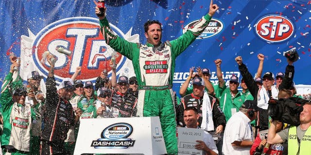JOLIET, IL - JULY 22: Elliott Sadler, driver of the #2 Hunt Brothers Pizza Chevrolet, celebrates winning the NASCAR Nationwide Series STP 300 at Chicagoland Speedway on July 22, 2012 in Joliet, Illinois. (Photo by Jonathan Daniel/Getty Images)