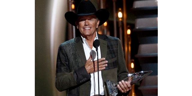 Nov. 6, 2013: George Strait accepts the award for entertainer of the year at the 47th annual CMA Awards at Bridgestone Arena in Nashville, Tenn.