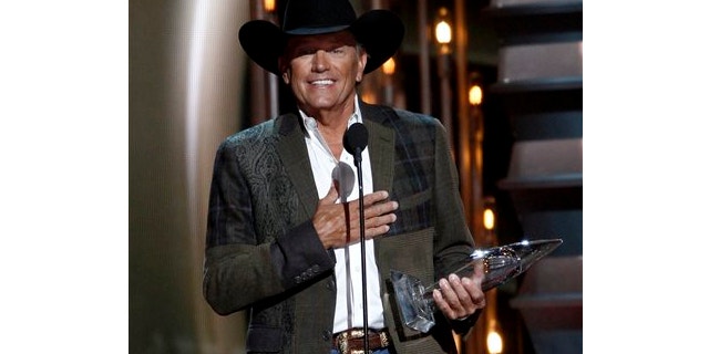 Nov. 6, 2013: George Strait accepts the award for entertainer of the year at the 47th annual CMA Awards at Bridgestone Arena in Nashville, Tenn.