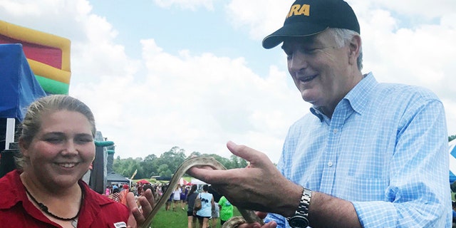 Aug. 12, 2017: Sen. Luther Strange, R, handles a snake as park naturalist Mandy Pearson looks on during a campaign stop in Heflin, Ala. (AP)