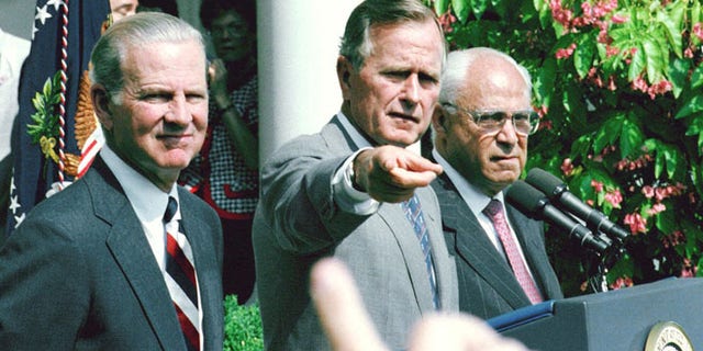 Aug. 20, 1991: President George H.W. Bush, flanked by Secretary of State James Baker III, left, and U. S. Ambassador to the Soviet Union Robert Strauss, points to a reporter during a Rose Garden press conference at the White House.