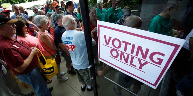 FILE: Aug. 13, 2011: Republicans enter Hilton Coliseum before casting their ballots in the Iowa Republican Part's straw poll, in Ames, Iowa.
