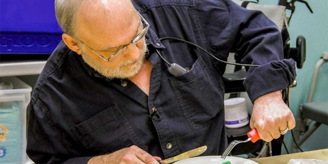 Ken Meeks is participating in a clinical trial that involves the use of a neurotransmitter implanted just below the skin on the chest to return some function to his arm.