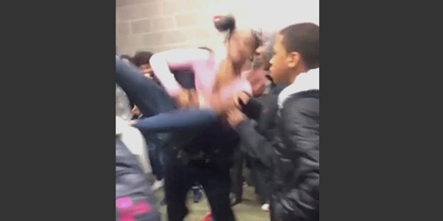 In this Tuesday, Jan. 3, 2017, image made from video and released by Pam C. Akpuda, officer Ruben De Los Santos of the Rolesville Police Department slams a teenage girl to the floor in Rolesville, N.C.
