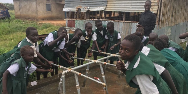 Good Shepherd Academy students at their well in Juba, Sudan
