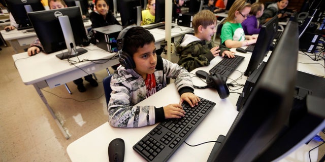 March 14, 2013: In this file photo, Alexis Maldonado works in a 5th grade computer lab at Van Buren Elementary School in Cedar Rapids, Iowa.