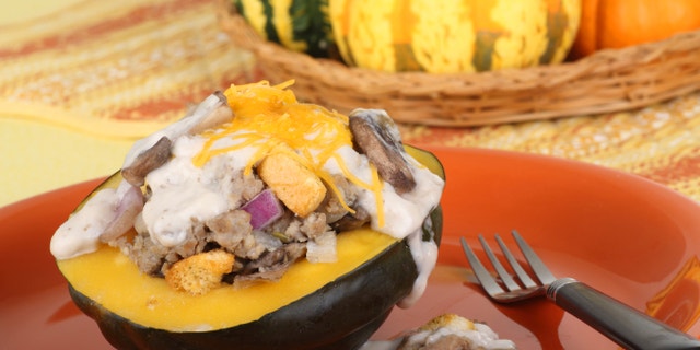 Baked stuffed acorn squash on an orange plate