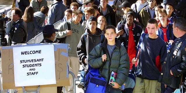 Oct 9, 2001: Students leave Stuyvesant High School at the end of the school day in New York City. The students were allowed to return to the school today for the first time since September 11. (Photo by Mario Tama/Getty Images)