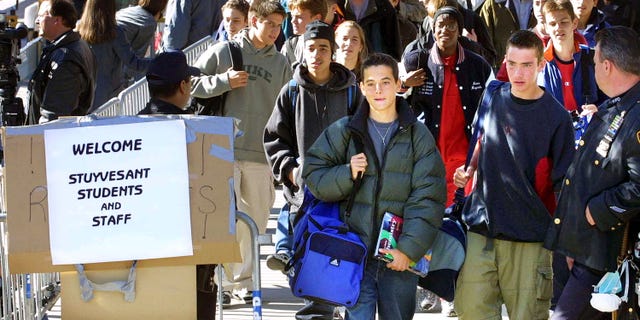 Oct 9, 2001: Students leave Stuyvesant High School at the end of the school day in New York City. The students were allowed to return to the school today for the first time since September 11. (Photo by Mario Tama/Getty Images)