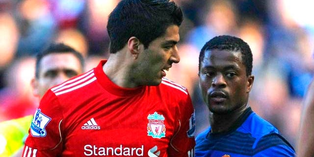 In this photo taken Saturday, Oct. 15, 2011, Manchester United's Patrice Evra argues with Liverpool's Luis Suarez, left, during their English Premier League soccer match at Anfield, Liverpool, England. The English Football Association has launched an investigation into allegations from Manchester United's Patrice Evra that he was racially abused by Liverpool striker Luis Suarez during Saturday's Premier League match. (AP Photo/Tim Hales)