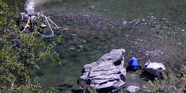 This photo provided by the Karuk tribe, shows a suction dredge.