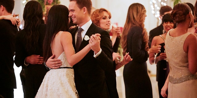 Markle and Patrick J. Adams share the first wedding dance during their 'Suits' wedding.