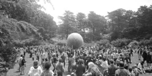 People celebrating the summer solstice on June 21, 1967, carry a large ball, painted to represent a world globe, in the air during a gathering at Golden Gate Park in San Francisco on Day One of "Summer of Love." (AP Photo/File)