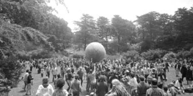 People celebrating the summer solstice on June 21, 1967, carry a large ball, painted to represent a world globe, in the air during a gathering at Golden Gate Park in San Francisco on Day One of "Summer of Love." (AP Photo/File)