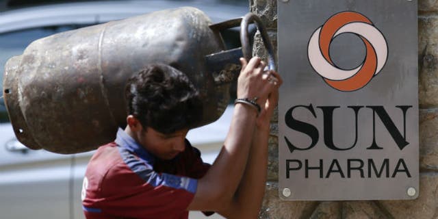 A man carrying a gas cylinder walks out of the research and development centre of Sun Pharmaceutical Industries Ltd in Mumbai May 29, 2014. (REUTERS/Danish Siddiqui)