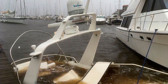 The mast of a sunken boat sits at a dock at the Grand View Marina in New Bern, N.C., on Friday, Sept. 14, 2018. Winds and rains from Hurricane Florence caused the Neuse River to swell, swamping the coastal city.