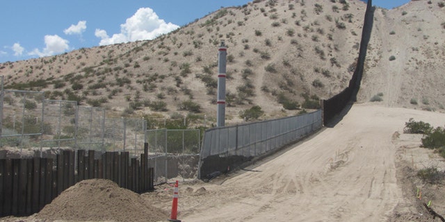 The old chainlink fence alongside SunlandPark is being replaced by an 18-foot high steel wall.