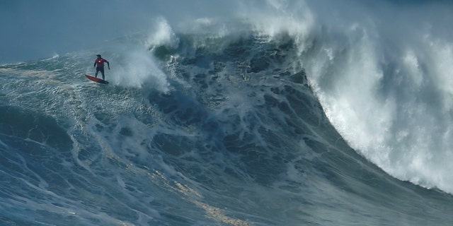 File photo: A surfer drops in on a large wave at Praia do Norte in Nazare, Portugal, February 10, 2017. (REUTERS/Rafael Marchante )